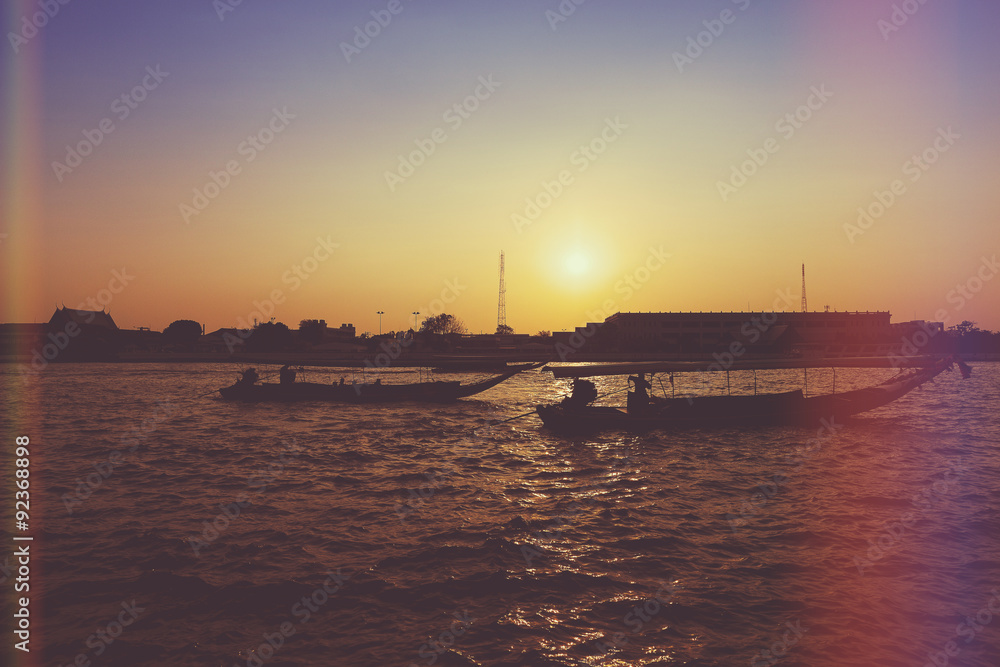 Obraz premium River boats crossing the Chao Phraya river in Bangkok, Thailand. with light leak filter.