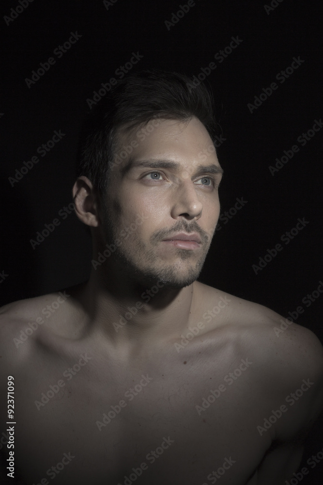 Portrait of beautiful young man looking to light.
