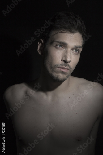 Beauty portrait of young man looking away to right