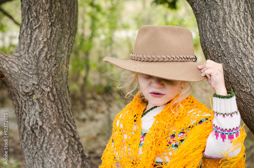 girl with hat and orange pelerine in autumn season photo