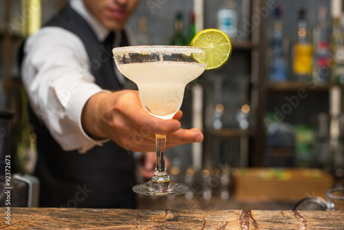 Barman serving margarita cocktail, concept for cocktails photo