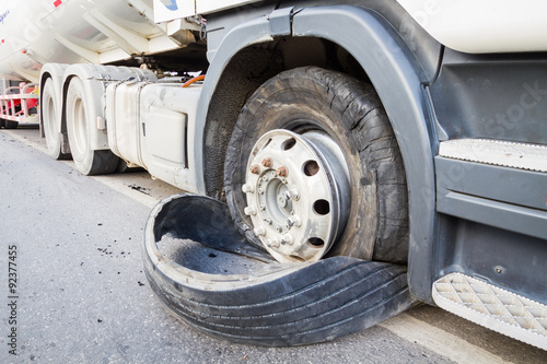 closeup damaged 18 wheeler semi truck burst tires by highway str