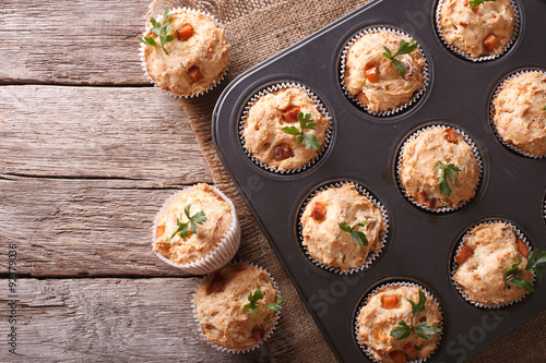 muffins with ham and cheese in baking dish. Horizontal top view
