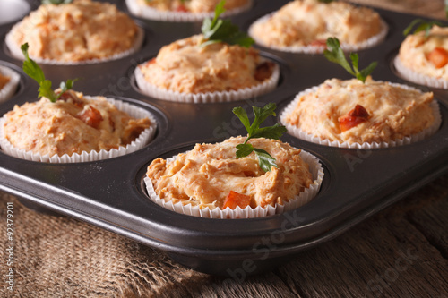 muffins with ham and cheese in baking dish close up. horizontal
