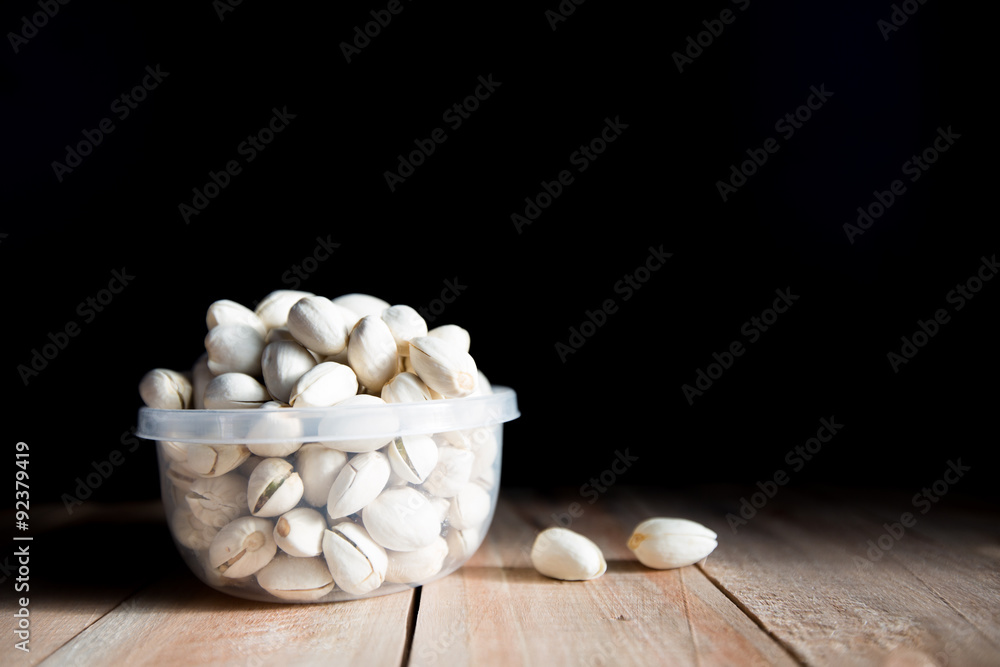 Pistachio put in bowl and some the wood floor Pistachio put in bowl and some the wood floor