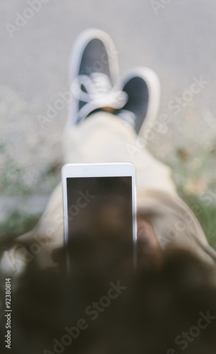 Young man with mobile phone...