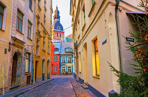 Narrow street leading to the St. Peter church in Old Riga photo