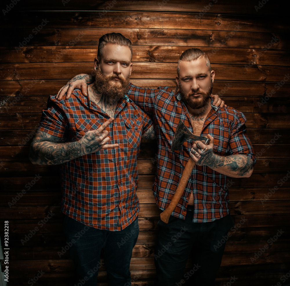 Obraz premium Two mans with beards and tattoo.