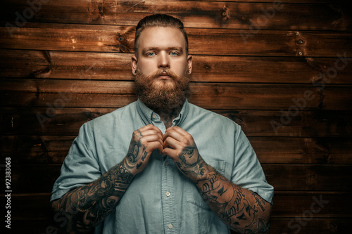 Brutal man with beard and tatoos.