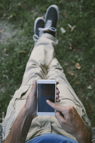 Young man with mobile phone...