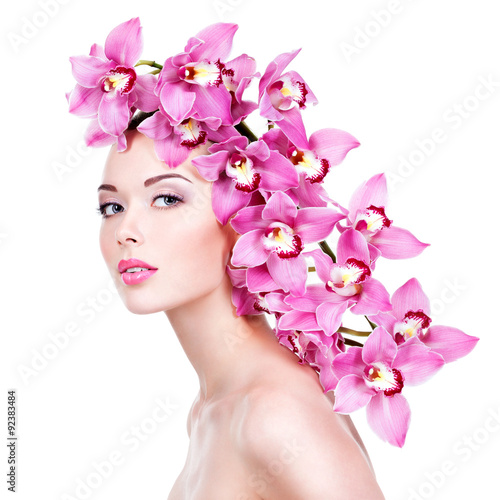 Portrait of  beautiful woman with a pink flowers