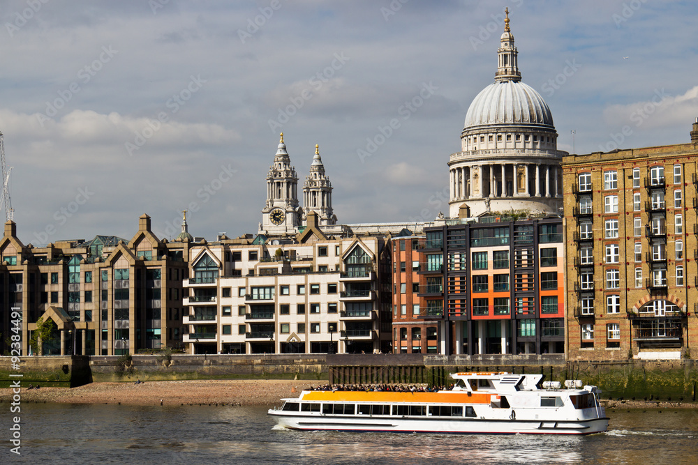 Sightseeing boat filled with tourists on river Thames in London,