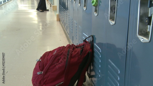 A large backpack sitting outside a locker photo