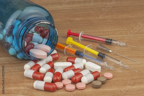 Doping in sport. Abuse of anabolic steroids for sports. Anabolic steroids spilled on a wooden table. Fraud in sports. Pharmaceutical industry. Detailed view of the medication. Place for your text.
