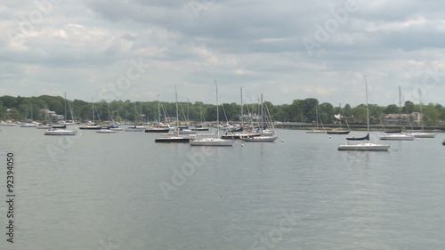 Sailboats moored in harbor photo