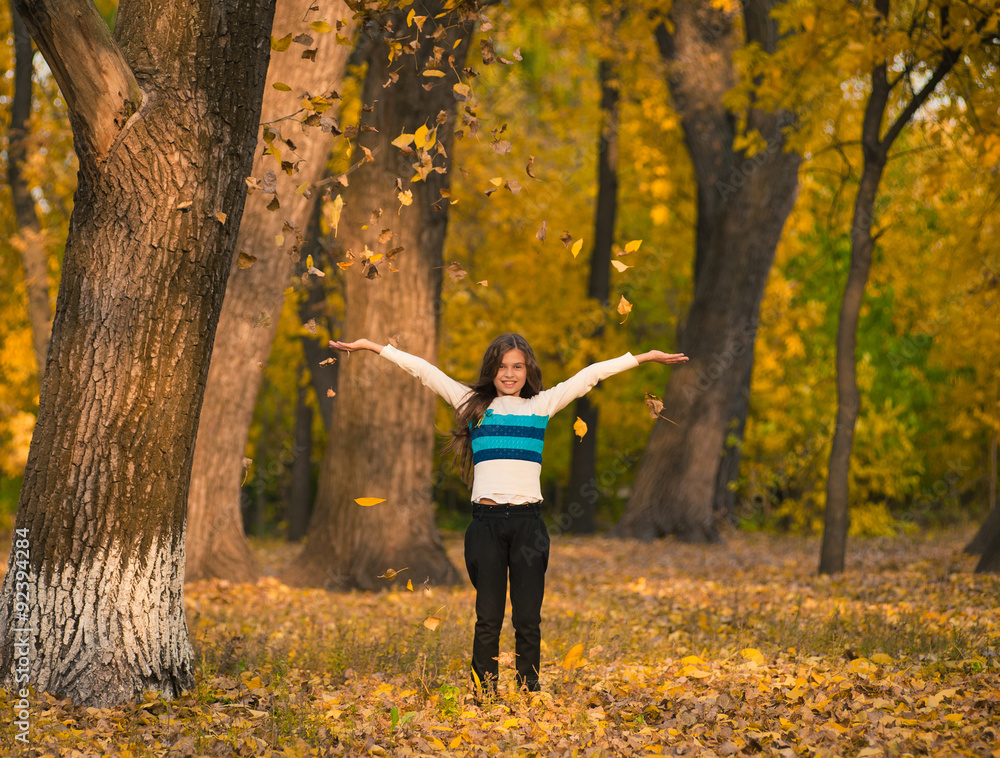 Pretty girl playing with autumn leaves in park Pretty girl playing with autumn leaves in park