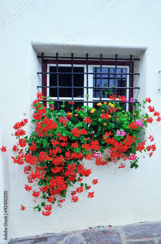 typical flowered balcony in South Tyrolean valley of South Tyrol racines photo