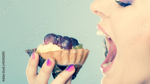woman face profile open mouth eating cake