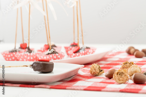 Cake-pop on wooden table.