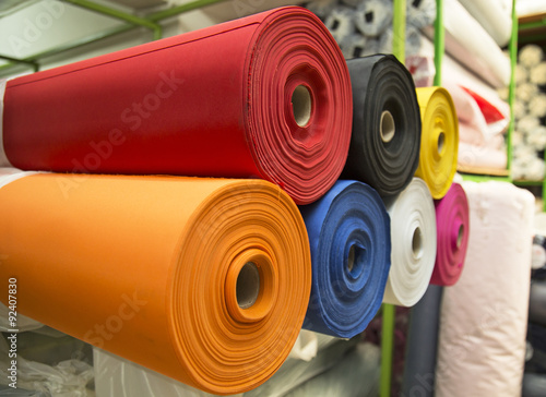 Colorful material fabric rolls in warehouse