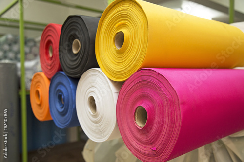 Colorful material fabric rolls in warehouse