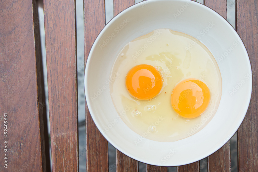 raw egg yolk on the dish on table raw egg yolk on the dish on table