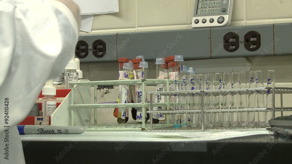 Technician fills tubes using dropper Technician fills tubes using dropper