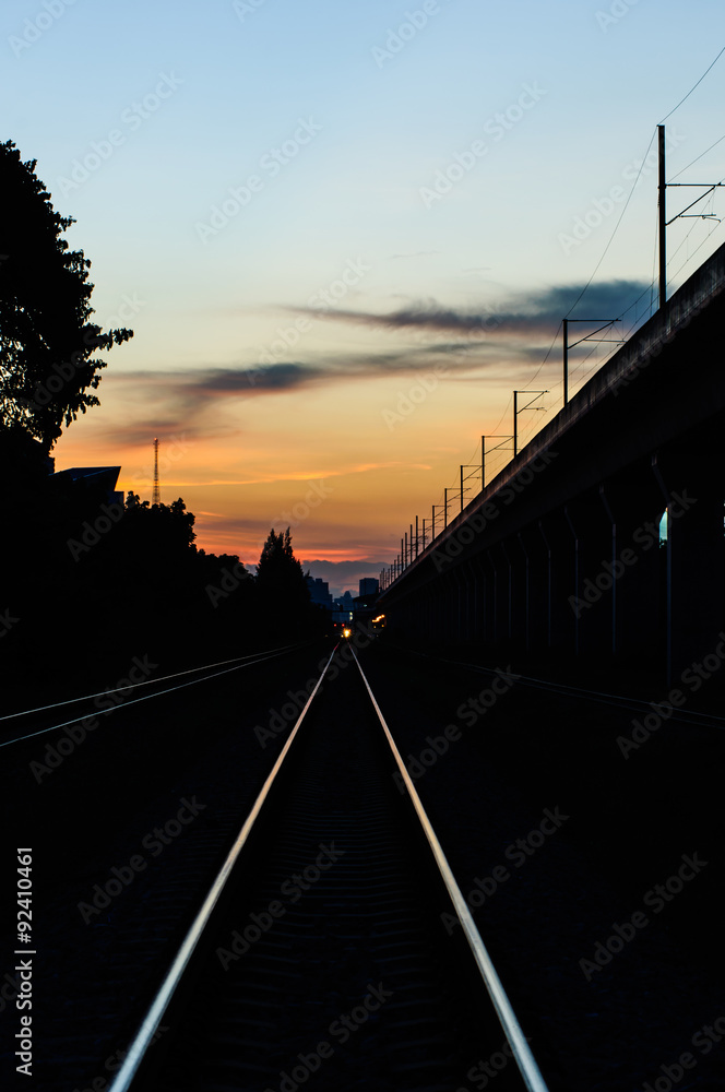 railway tracks in the shadow light of sunset.