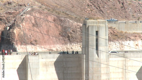 Automobiles and tourists cross the Hoover Dam