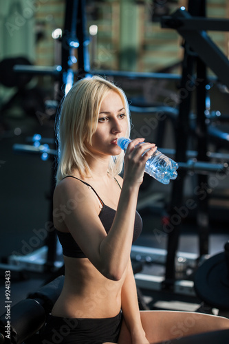 Girl in gym drinking water