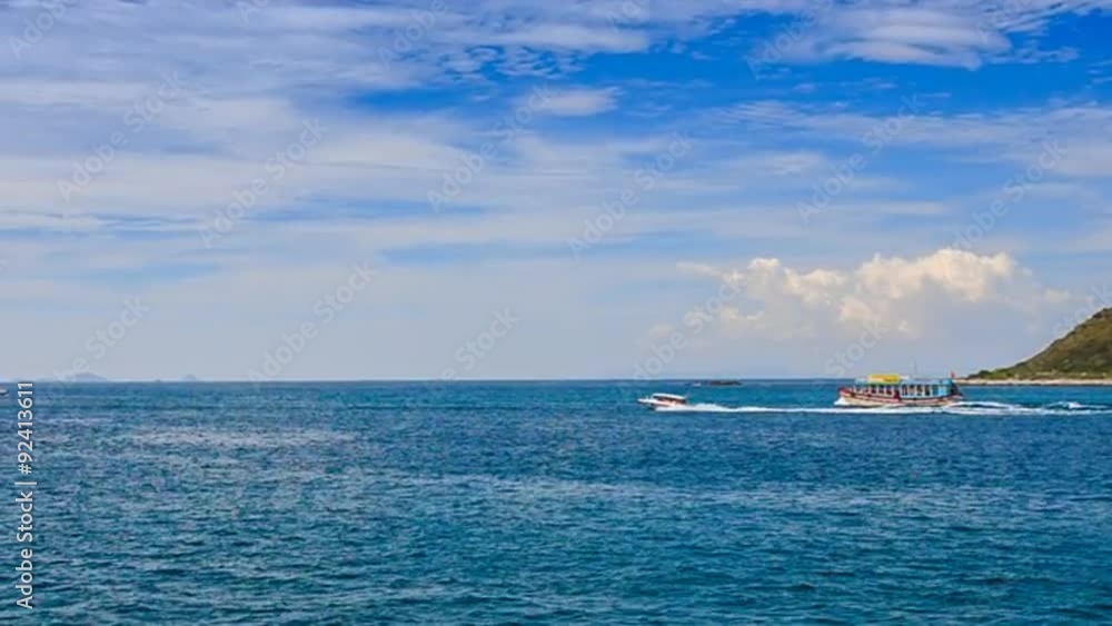 motorboat outruns large boat against island and boundless sea motorboat outruns large boat against island and boundless sea