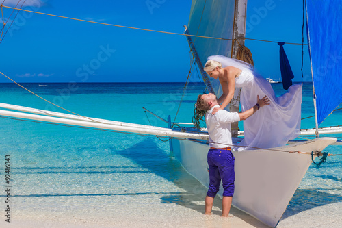 young loving couple, bride and groom, on their wedding day on sa