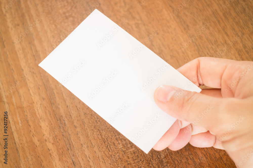 Hand holding a business card Hand holding a business card