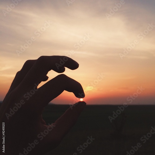 sun in the man hand sunset