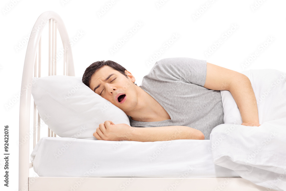 Young guy sleeping on a bed Young guy sleeping on a bed