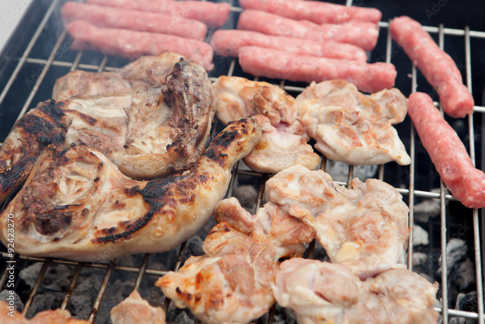 Chicken and sausages on the barbecue Chicken and sausages on the barbecue