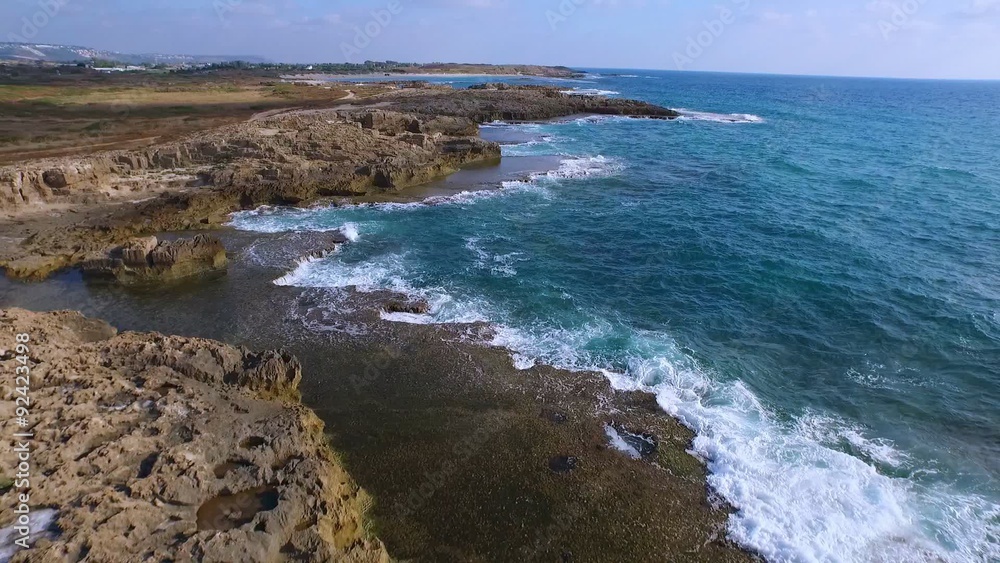 The charming beach, azure waves are beating against the rocks. The charming beach, azure waves are beating against the rocks.