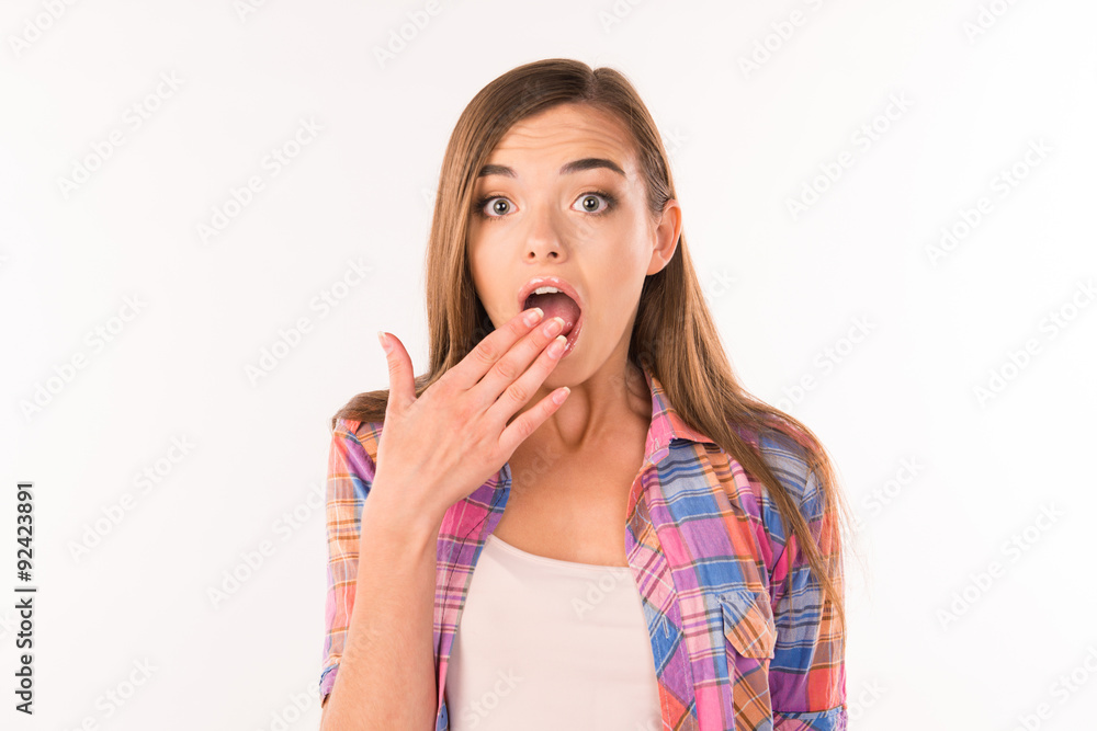 Surprised young woman covered her mouth with hand Surprised young woman covered her mouth with hand