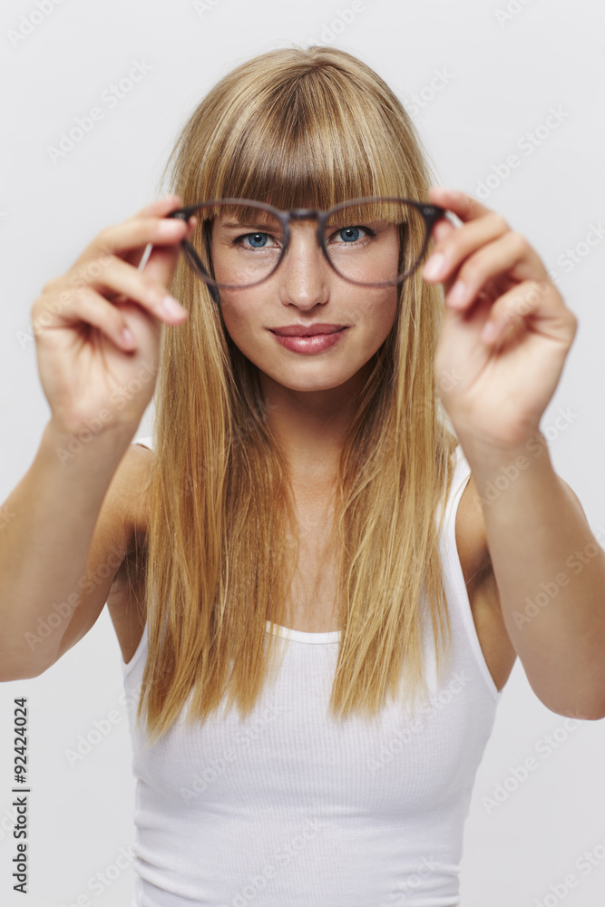 Confident young student with spectacles in studio Confident young student with spectacles in studio
