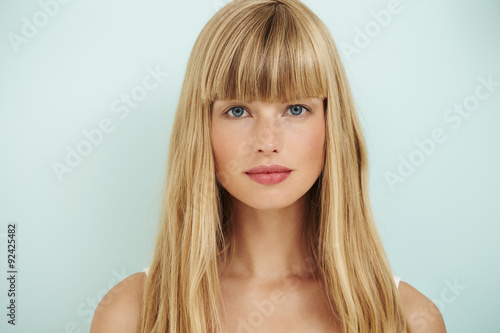 Young blond woman on blue background