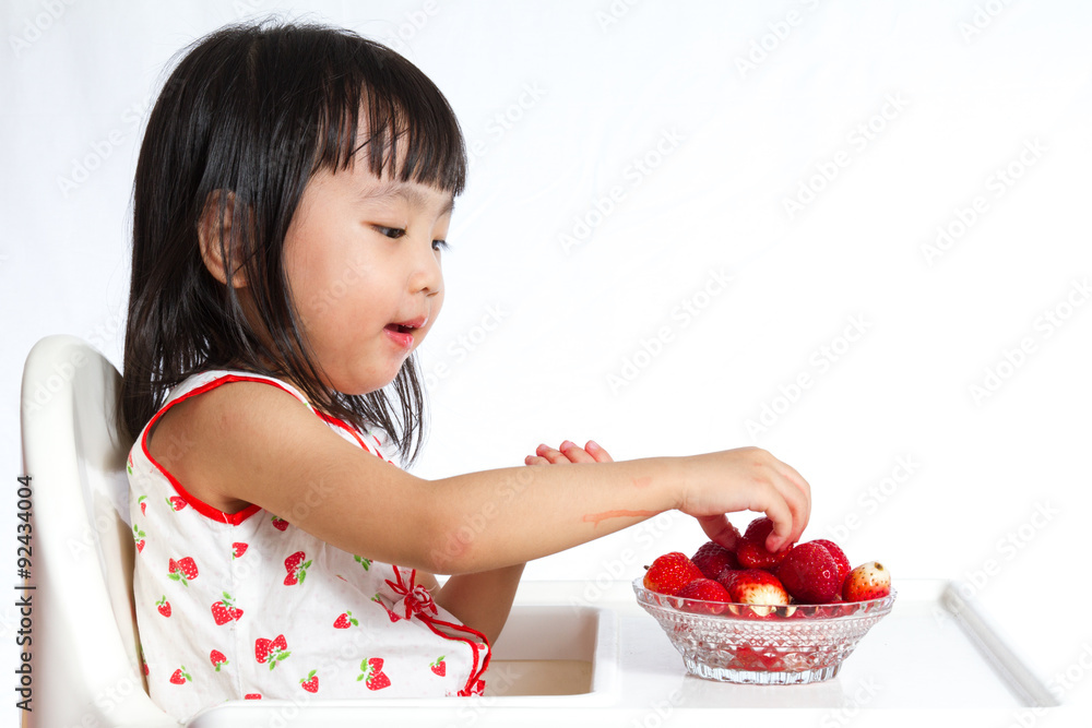 Asian Chinese little girl eating strawberries Asian Chinese little girl eating strawberries