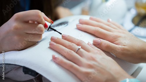 Woman hand on manicure treatment in beauty salon. 