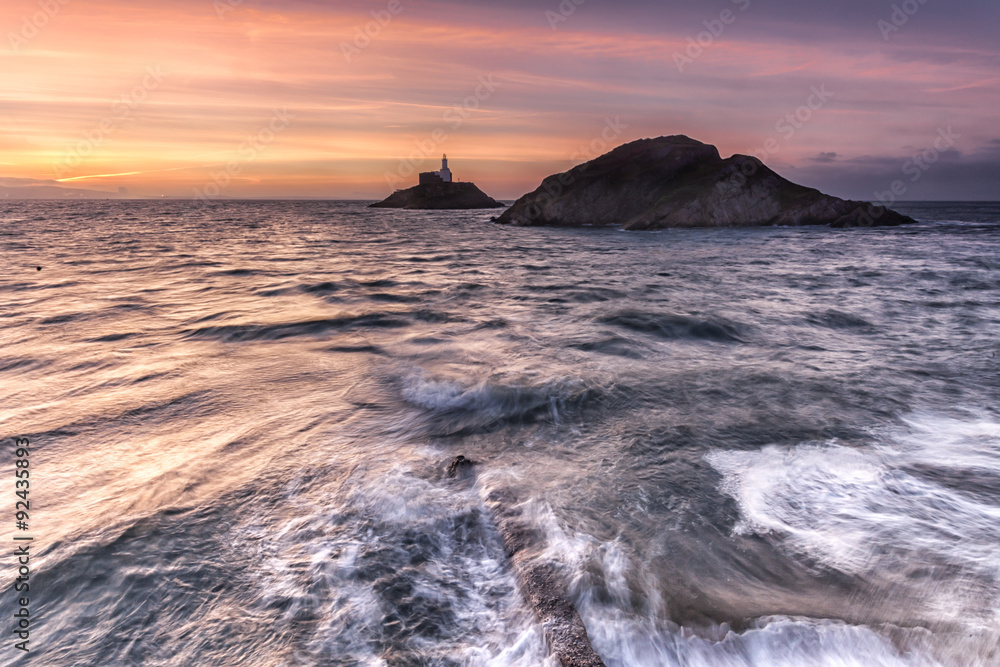 Dawn at Mumbles Lighthouse, Swansea, shot from the entrance to the pier