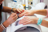 Woman hand on manicure treatment in beauty salon. 