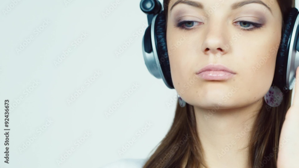 Attractive brunette with headphones lipstick tints Attractive brunette with headphones lipstick tints