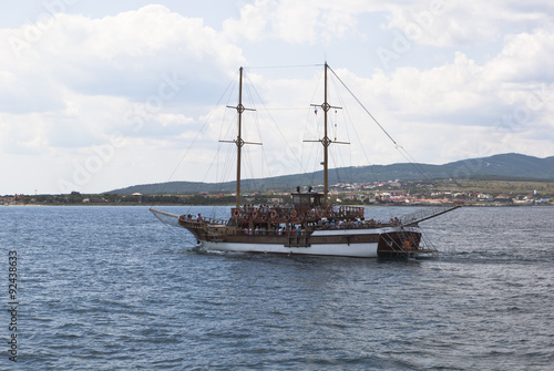Парусное судно "Корсар" плывёт в Геленджикской бухте на фоне Тонкого мыса, Краснодарский край, Россия