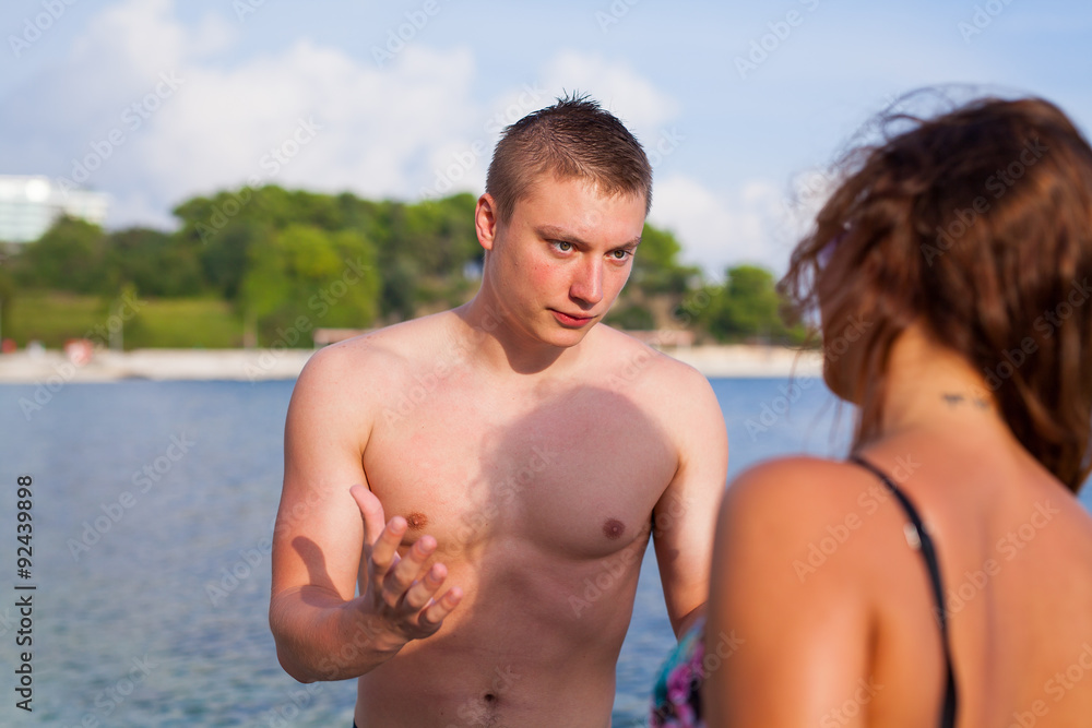 A couple standing on the seashore. They are angry. A couple standing on the seashore. They are angry.