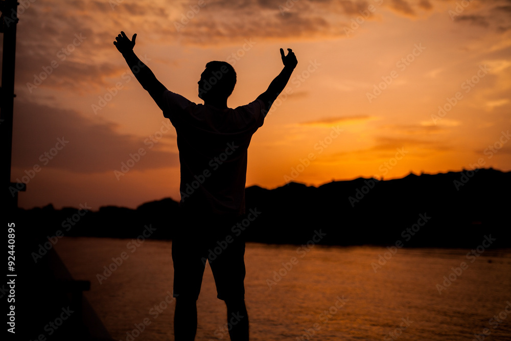 A man standing on the background of sunset