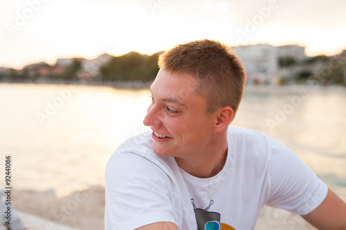 Man spending time on seashore in colorfull shirt.