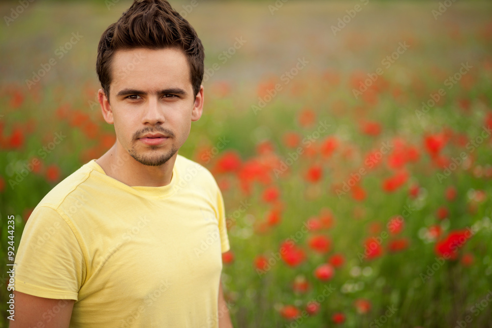 Portrait of a young man wearing yellow t-shirt standing in a field of poppies
Portrait of a young man wearing yellow t-shirt standing in a field of poppies